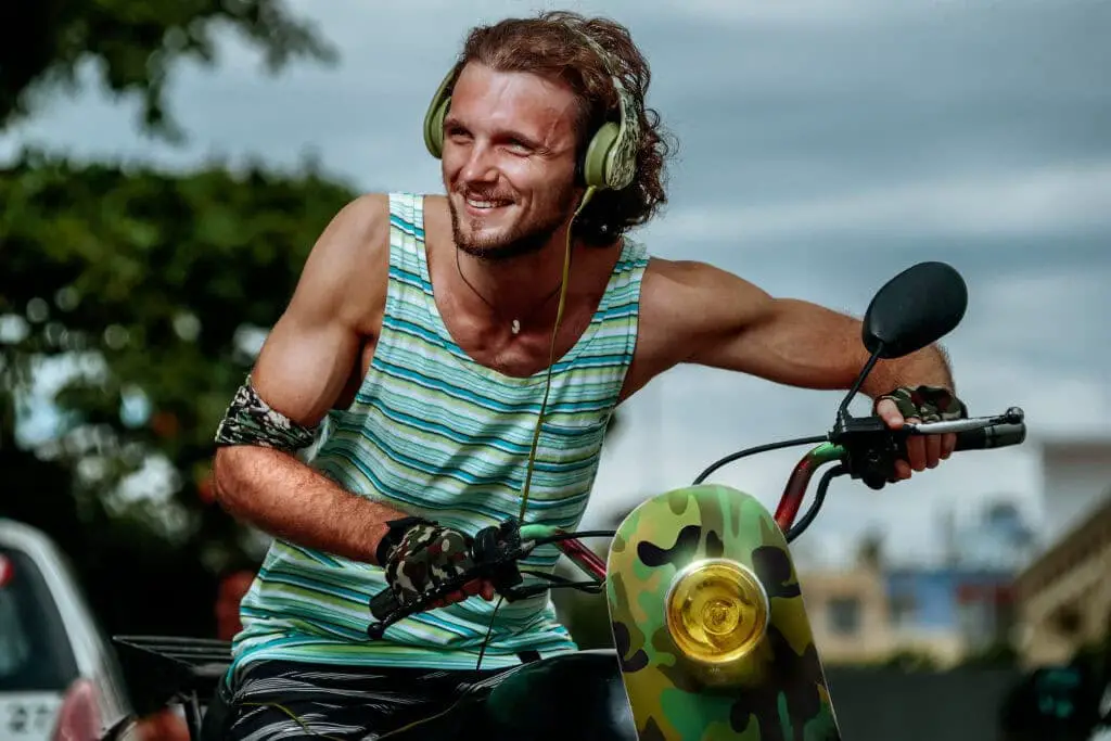 man in stripes tee riding a motorcycle