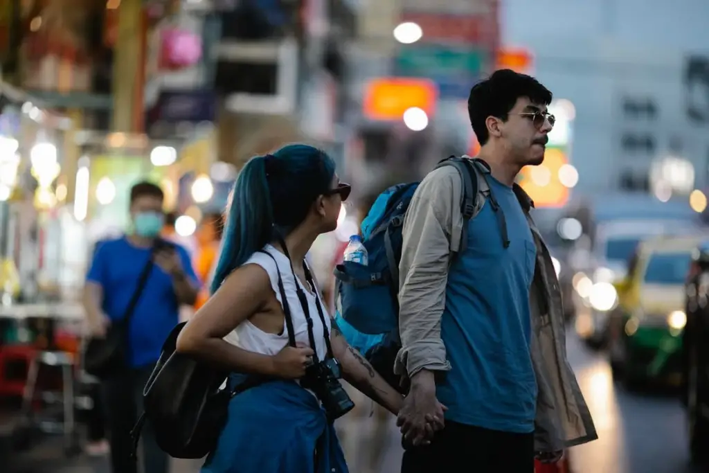 couple holding hands while walking
